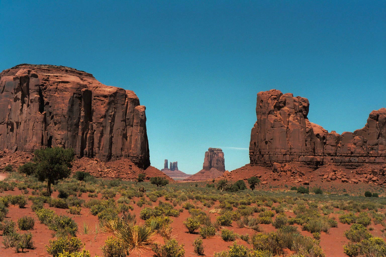 Huge, crumbling, red sandstone formations, as seen in many old Westerns.