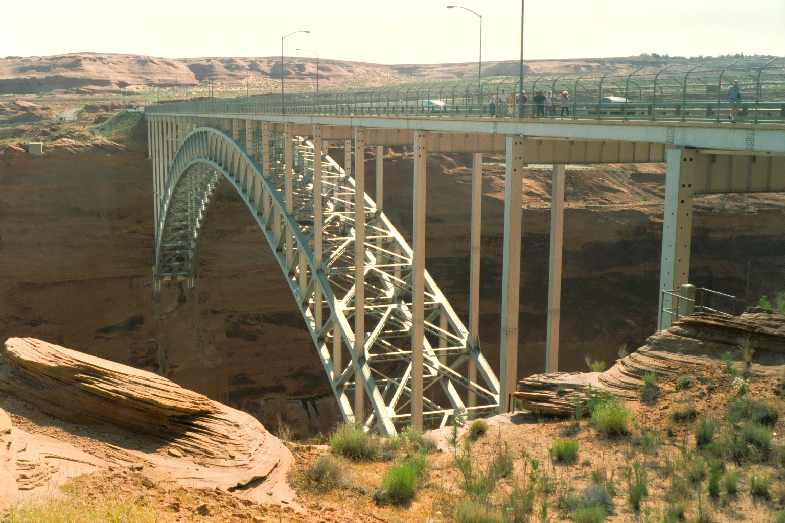 A massive bridge spans the mouth of the Lake Powell dam.