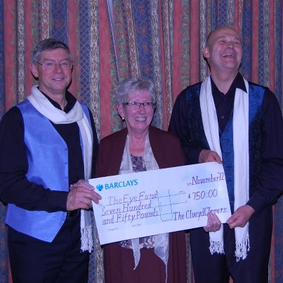 Carol Sherry being presented with a huge cheque by two members of Clywd Clippers.